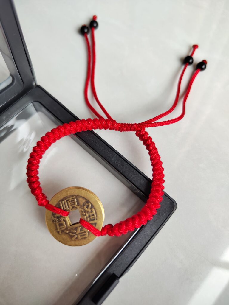 Five Emperor Coins Red Cord Bracelet handmade with traditional Vajra Knot, adjustable Chinese Feng Shui jewelry for protection.