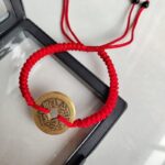 Five Emperor Coins Red Cord Bracelet handmade with traditional Vajra Knot, adjustable Chinese Feng Shui jewelry for protection.