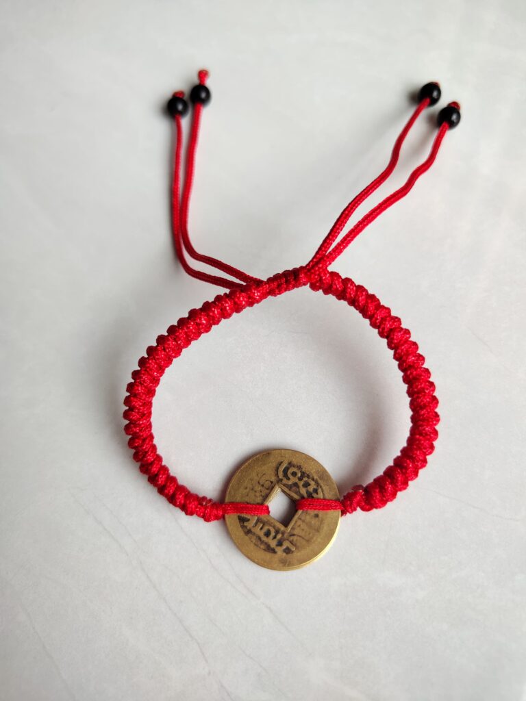 Five Emperor Coins Red Cord Bracelet handmade with traditional Vajra Knot, adjustable Chinese Feng Shui jewelry for protection.