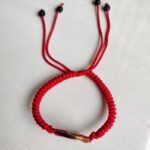 Five Emperor Coins Red Cord Bracelet handmade with traditional Vajra Knot, adjustable Chinese Feng Shui jewelry for protection.