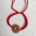 Five Emperor Coins Red Cord Bracelet handmade with traditional Vajra Knot, adjustable Chinese Feng Shui jewelry for protection.