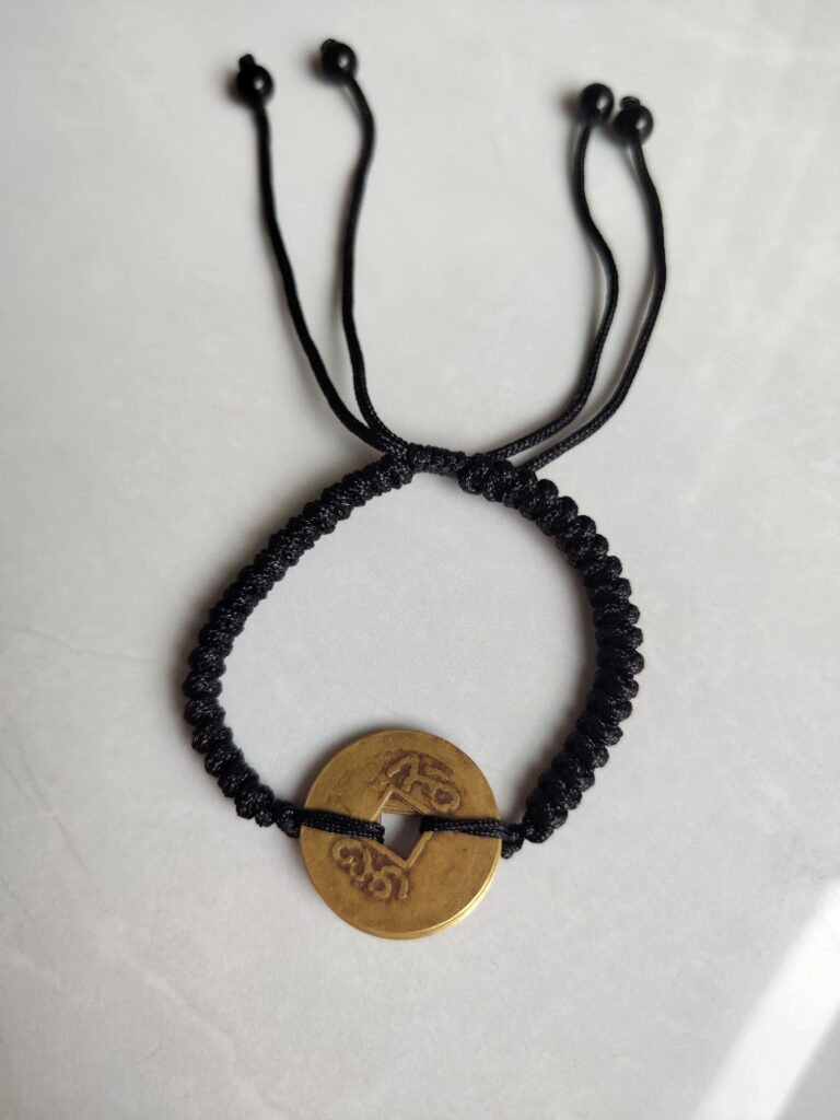 Five Emperor Coins Black Cord Bracelet handmade with traditional Vajra Knot, adjustable Chinese Feng Shui jewelry for protection.