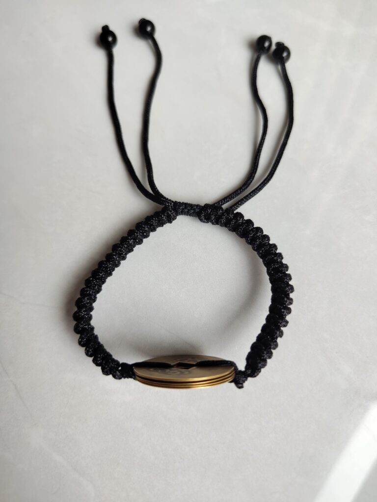 Five Emperor Coins Black Cord Bracelet handmade with traditional Vajra Knot, adjustable Chinese Feng Shui jewelry for protection.