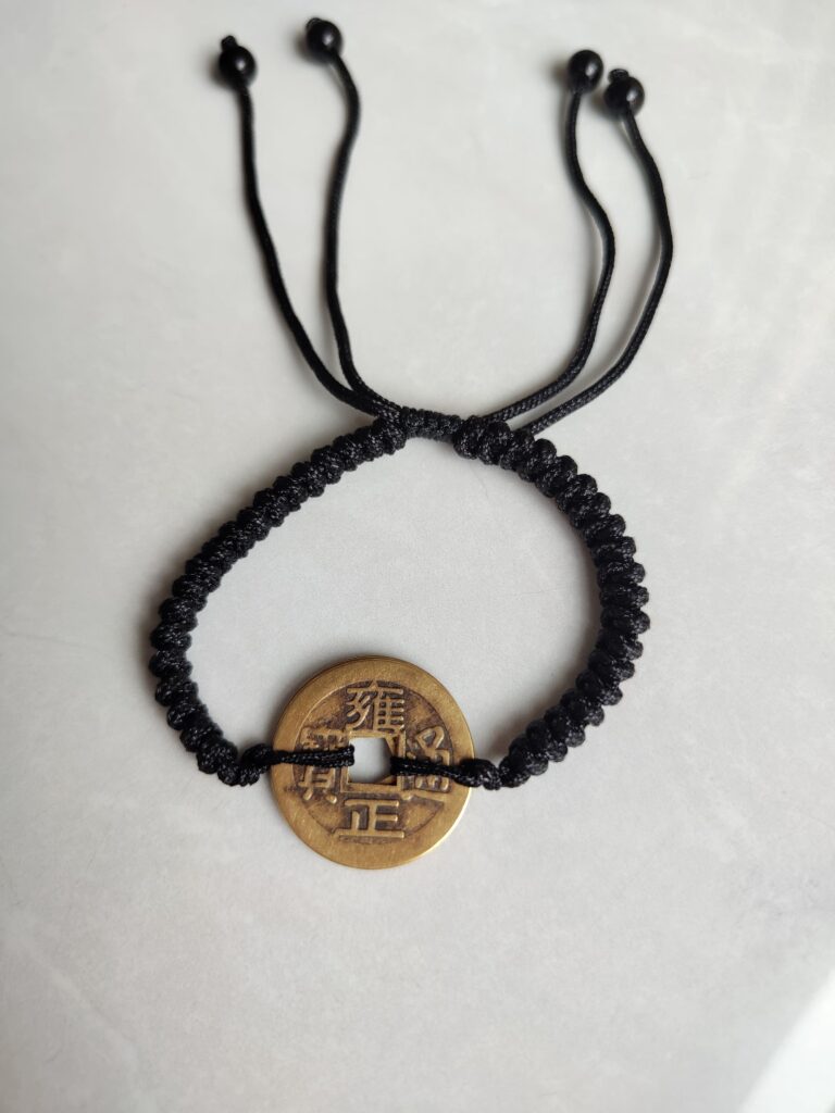 Five Emperor Coins Black Cord Bracelet handmade with traditional Vajra Knot, adjustable Chinese Feng Shui jewelry for protection.