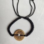 Five Emperor Coins Black Cord Bracelet handmade with traditional Vajra Knot, adjustable Chinese Feng Shui jewelry for protection.
