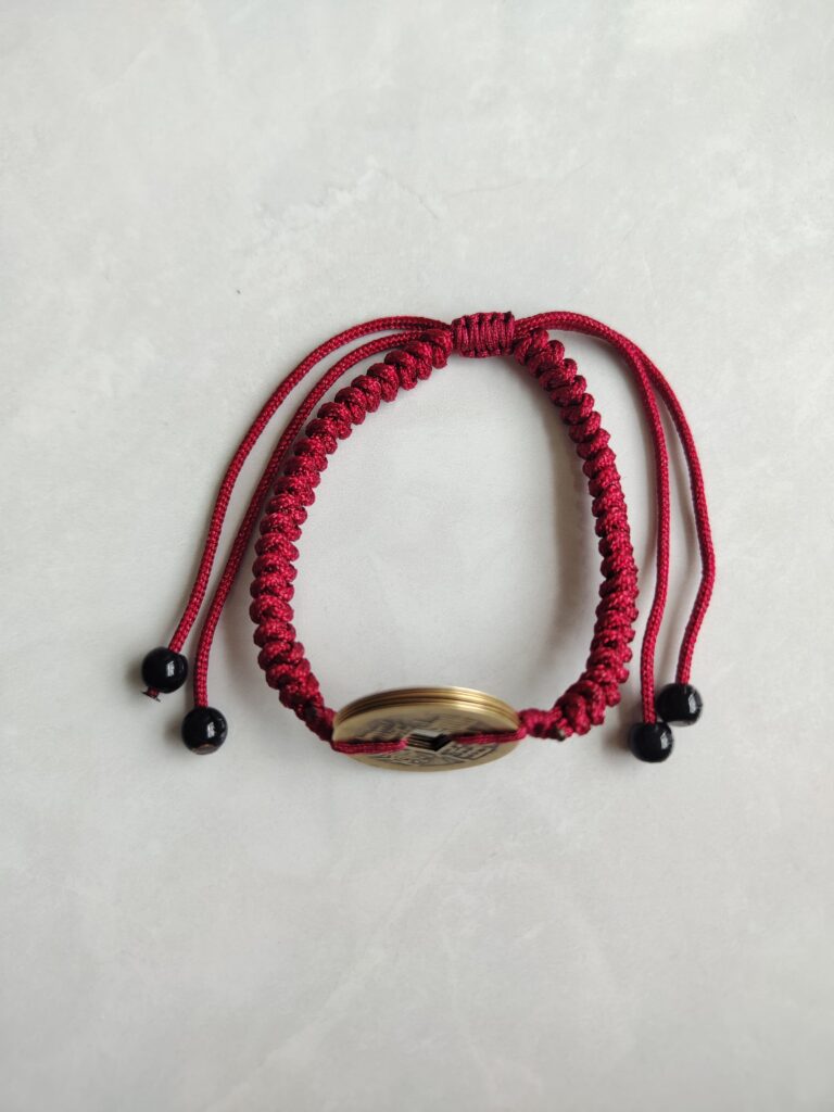 Five Emperor Coins Burgundy Cord Bracelet handmade with traditional Vajra Knot, adjustable Chinese Feng Shui jewelry for protection.