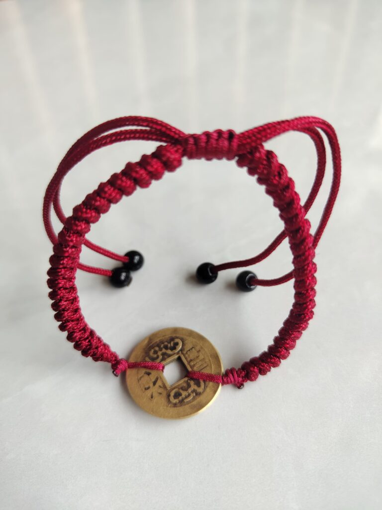 Five Emperor Coins Burgundy Cord Bracelet handmade with traditional Vajra Knot, adjustable Chinese Feng Shui jewelry for protection.