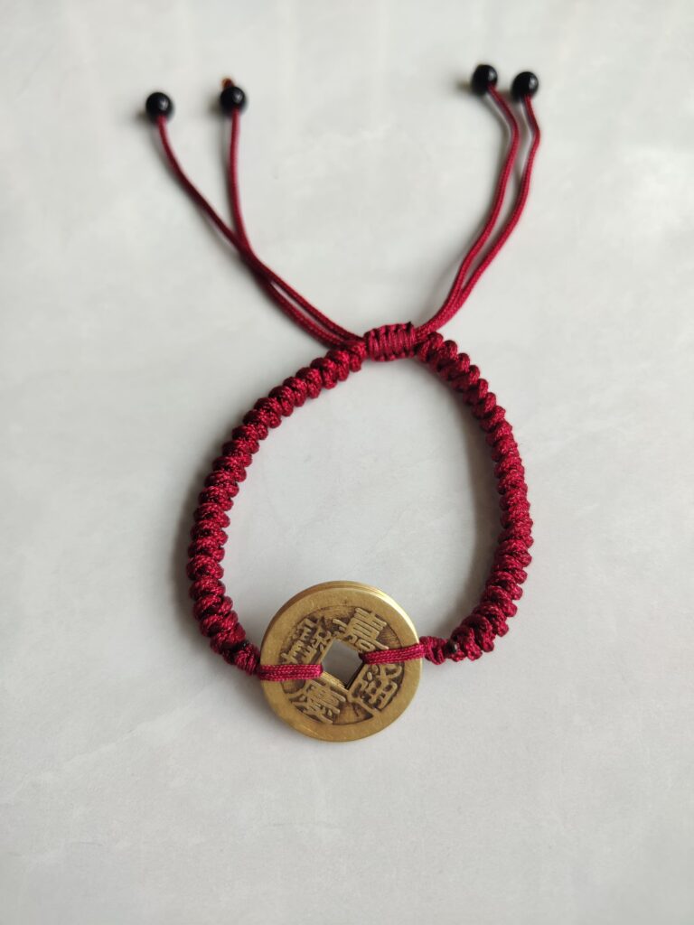Five Emperor Coins Burgundy Cord Bracelet handmade with traditional Vajra Knot, adjustable Chinese Feng Shui jewelry for protection.