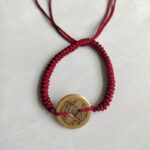 Five Emperor Coins Burgundy Cord Bracelet handmade with traditional Vajra Knot, adjustable Chinese Feng Shui jewelry for protection.
