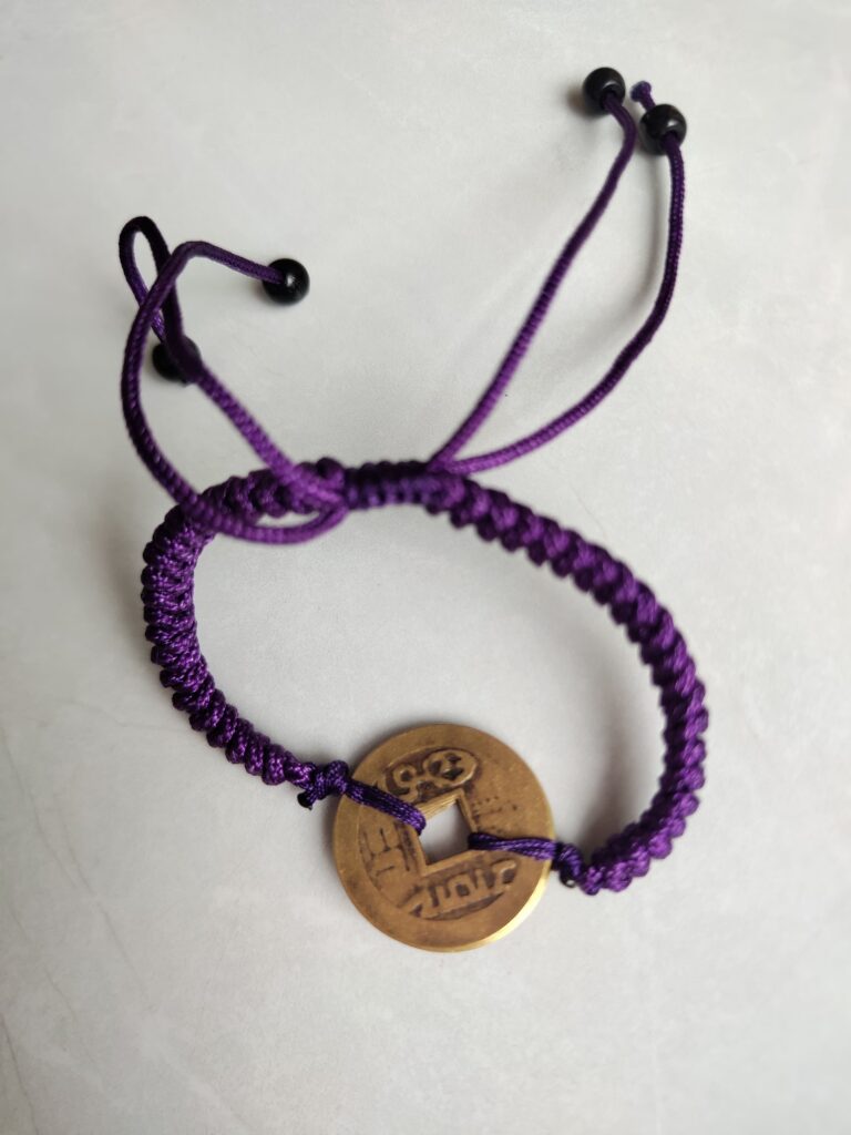 Five Emperor Coins Deep Purple Cord Bracelet handmade with traditional Vajra Knot, adjustable Chinese Feng Shui jewelry for protection.