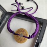 Five Emperor Coins Deep Purple Cord Bracelet handmade with traditional Vajra Knot, adjustable Chinese Feng Shui jewelry for protection.