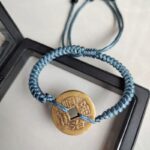 Five Emperor Coins Dusty Blue Cord Bracelet handmade with traditional Vajra Knot, adjustable Chinese Feng Shui jewelry for protection.