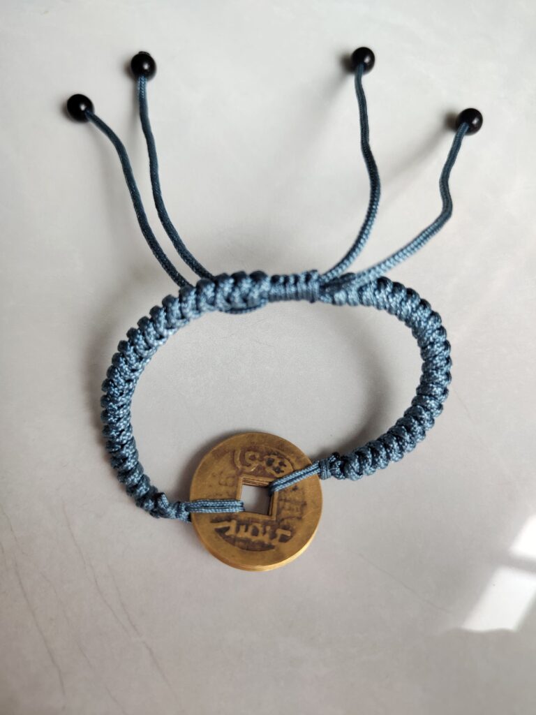 Five Emperor Coins Dusty Blue Cord Bracelet handmade with traditional Vajra Knot, adjustable Chinese Feng Shui jewelry for protection.
