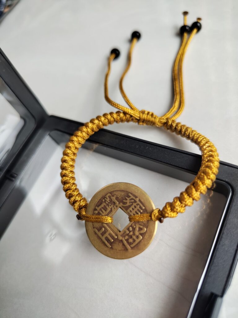 Five Emperor Coins Earth Yellow Cord Bracelet handmade with traditional Vajra Knot, adjustable Chinese Feng Shui jewelry for protection.