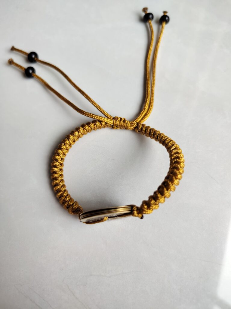 Five Emperor Coins Earth Yellow Cord Bracelet handmade with traditional Vajra Knot, adjustable Chinese Feng Shui jewelry for protection.