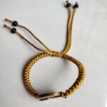 Five Emperor Coins Earth Yellow Cord Bracelet handmade with traditional Vajra Knot, adjustable Chinese Feng Shui jewelry for protection.