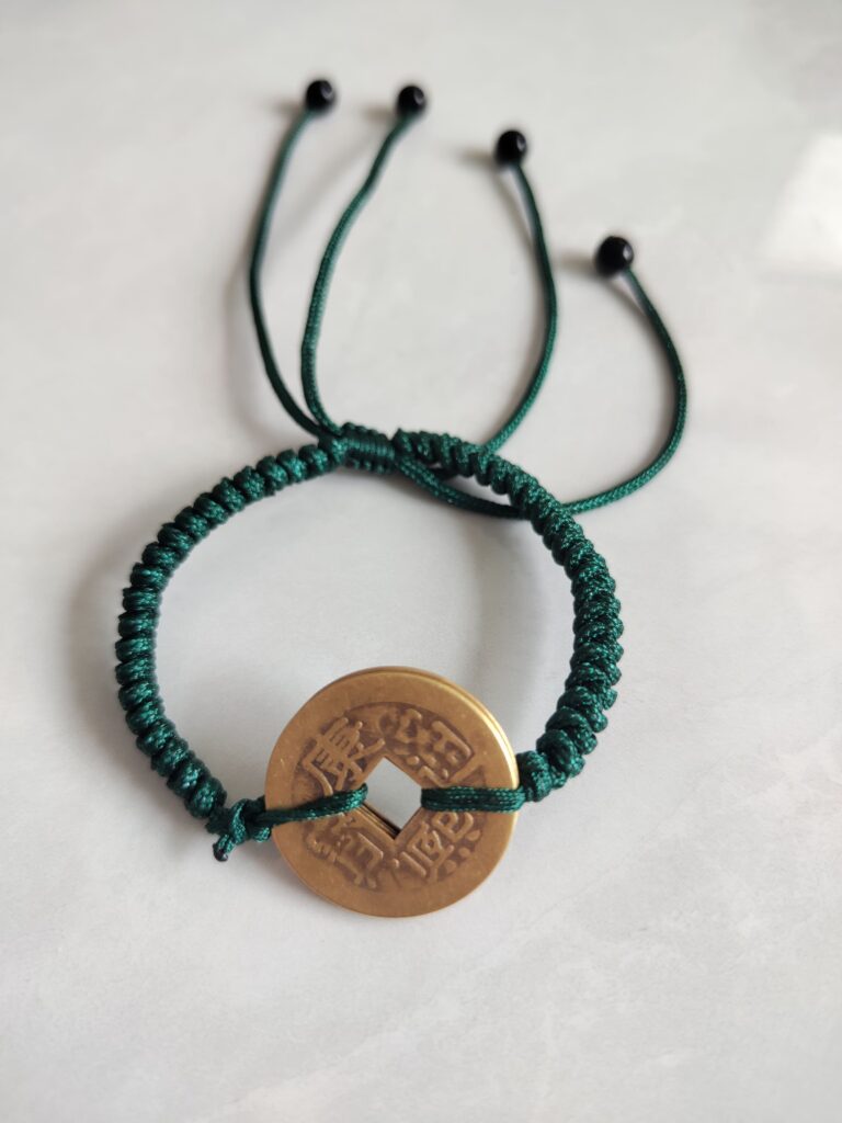 Five Emperor Coins Forest Green Cord Bracelet handmade with traditional Vajra Knot, adjustable Chinese Feng Shui jewelry for protection.