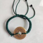 Five Emperor Coins Forest Green Cord Bracelet handmade with traditional Vajra Knot, adjustable Chinese Feng Shui jewelry for protection.