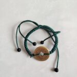 Five Emperor Coins Forest Green Cord Bracelet handmade with traditional Vajra Knot, adjustable Chinese Feng Shui jewelry for protection.