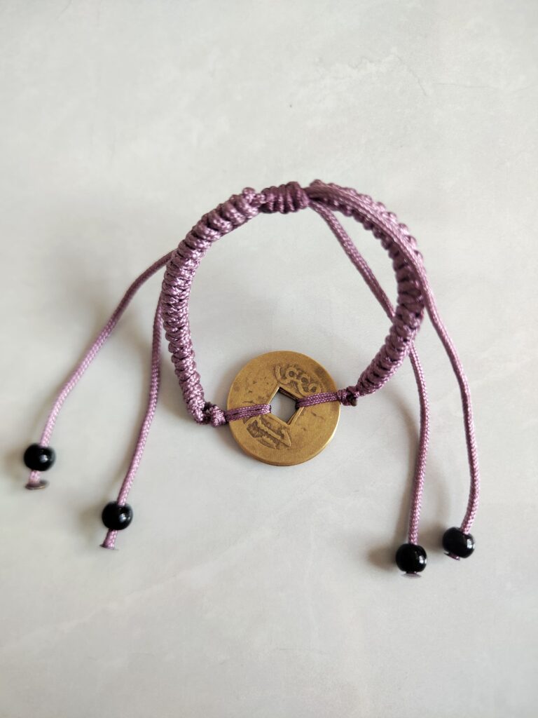 Five Emperor Coins Grey Purple Cord Bracelet handmade with traditional Vajra Knot, adjustable Chinese Feng Shui jewelry for protection.