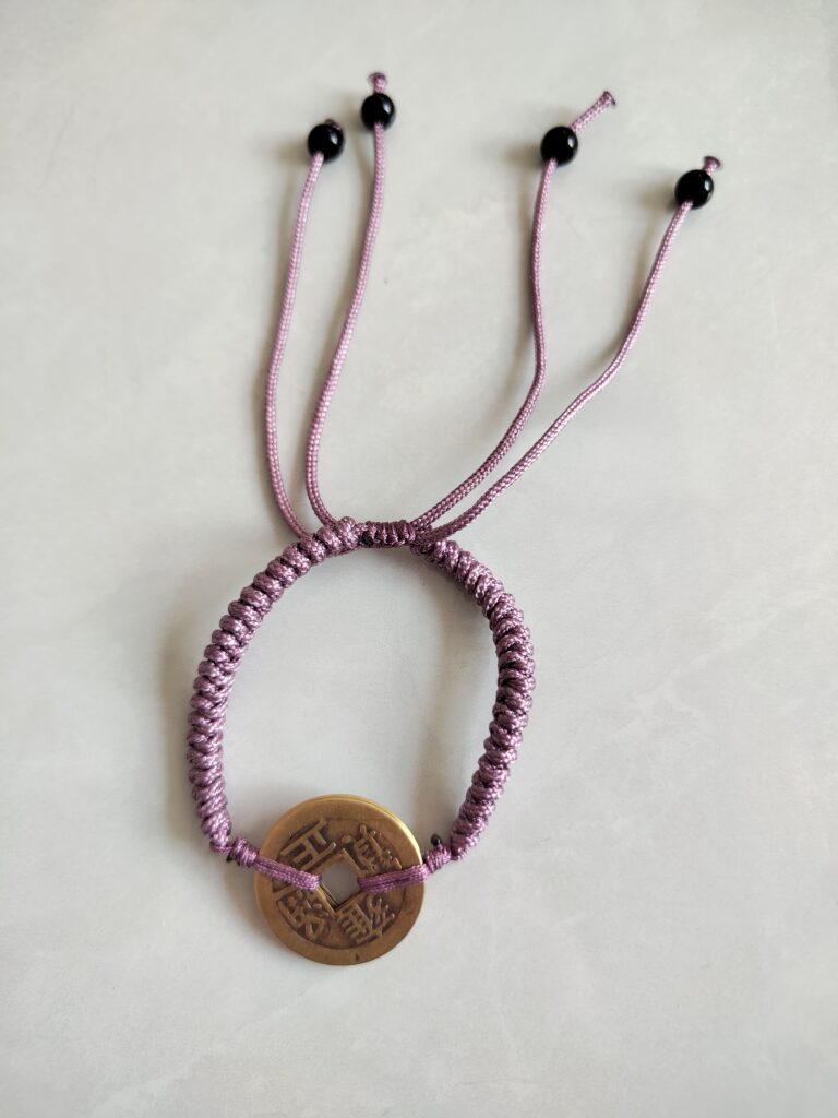 Five Emperor Coins Grey Purple Cord Bracelet handmade with traditional Vajra Knot, adjustable Chinese Feng Shui jewelry for protection.