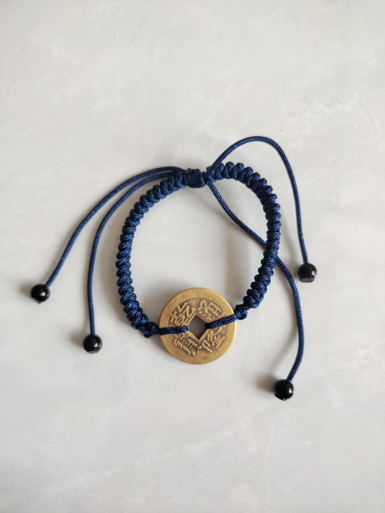 Five Emperor Coins Navy Blue Cord Bracelet handmade with traditional Vajra Knot, adjustable Chinese Feng Shui jewelry for protection.