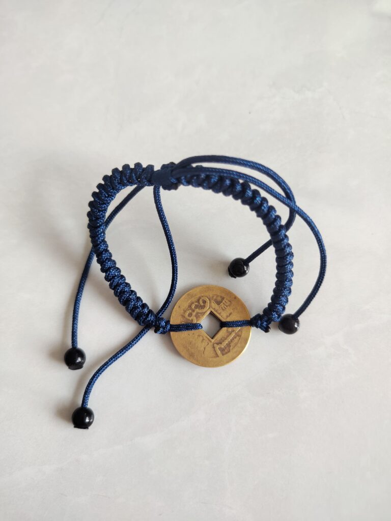 Five Emperor Coins Navy Blue Cord Bracelet handmade with traditional Vajra Knot, adjustable Chinese Feng Shui jewelry for protection.