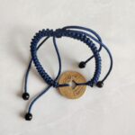 Five Emperor Coins Navy Blue Cord Bracelet handmade with traditional Vajra Knot, adjustable Chinese Feng Shui jewelry for protection.