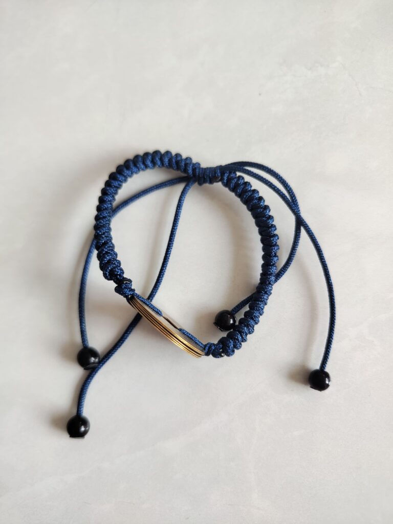 Five Emperor Coins Navy Blue Cord Bracelet handmade with traditional Vajra Knot, adjustable Chinese Feng Shui jewelry for protection.