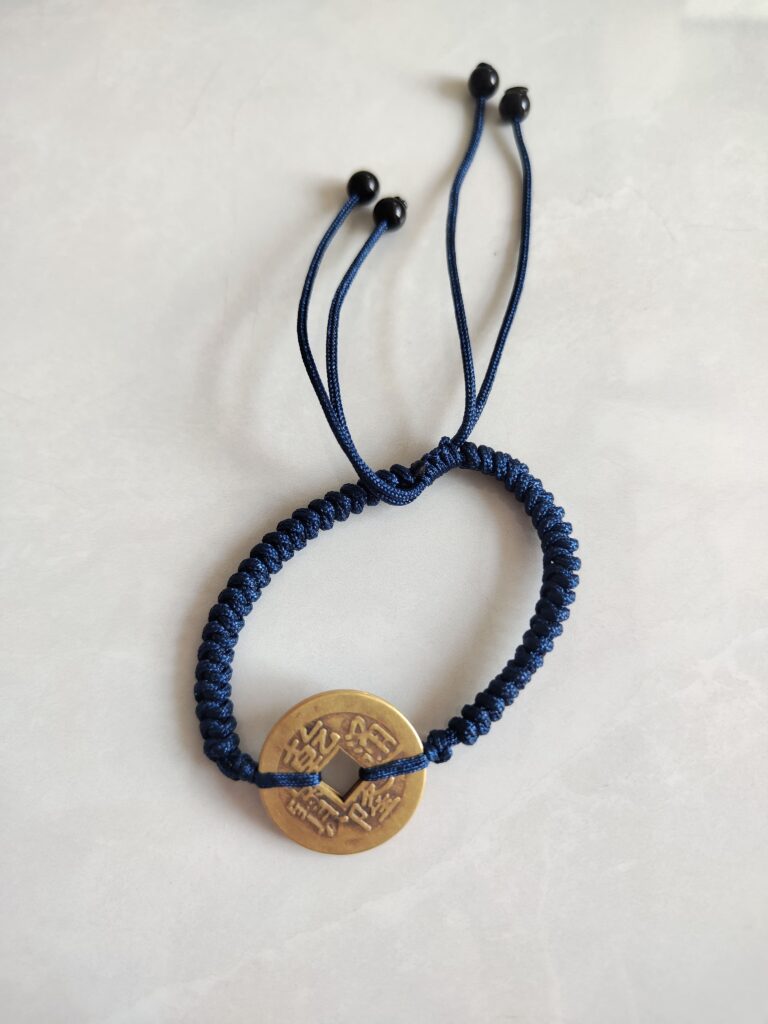 Five Emperor Coins Navy Blue Cord Bracelet handmade with traditional Vajra Knot, adjustable Chinese Feng Shui jewelry for protection.