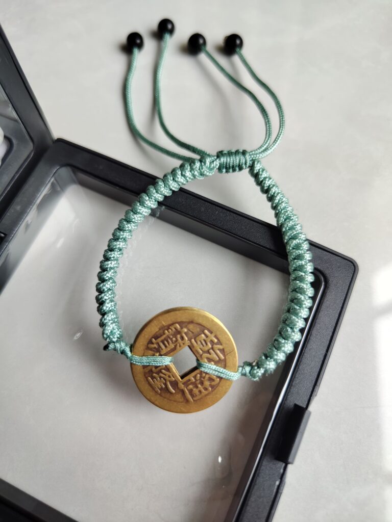 Five Emperor Coins Olive Green Cord Bracelet handmade with traditional Vajra Knot, adjustable Chinese Feng Shui jewelry for protection.