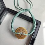 Five Emperor Coins Olive Green Cord Bracelet handmade with traditional Vajra Knot, adjustable Chinese Feng Shui jewelry for protection.