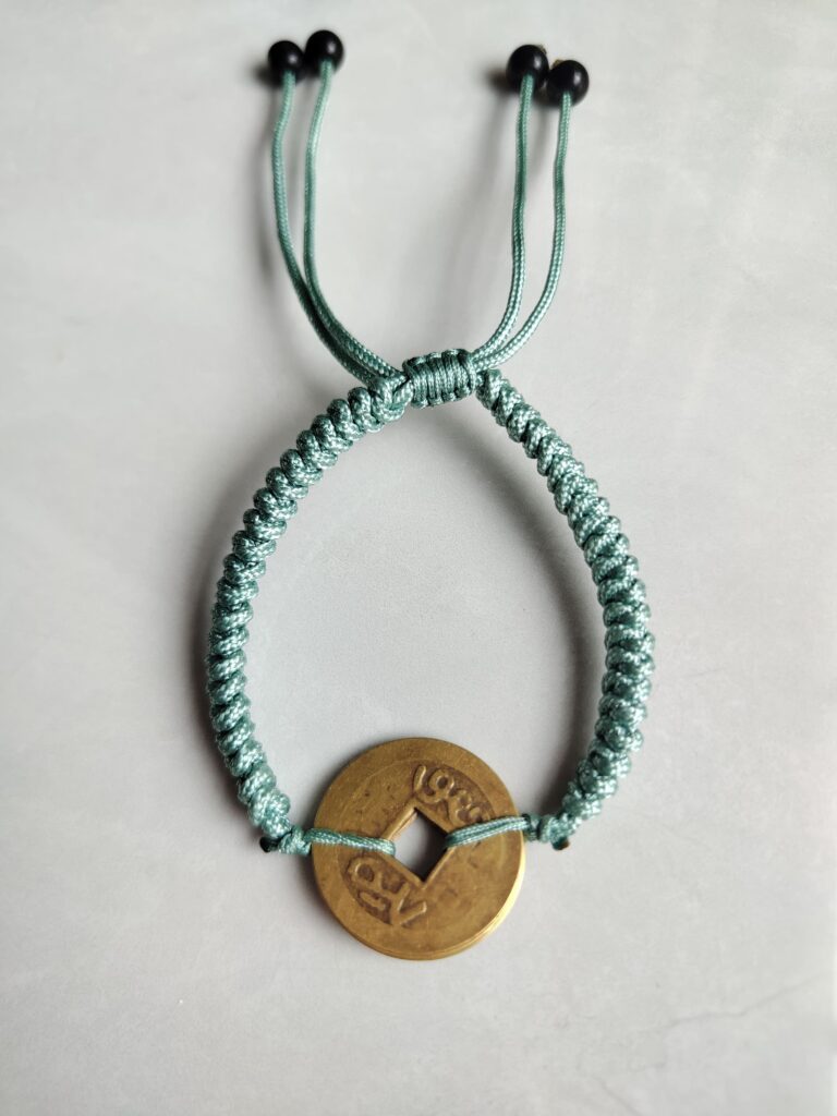 Five Emperor Coins Olive Green Cord Bracelet handmade with traditional Vajra Knot, adjustable Chinese Feng Shui jewelry for protection.