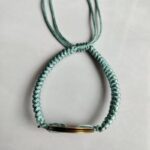 Five Emperor Coins Olive Green Cord Bracelet handmade with traditional Vajra Knot, adjustable Chinese Feng Shui jewelry for protection.