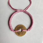 Five Emperor Coins Peach Pink Cord Bracelet handmade with traditional Vajra Knot, adjustable Chinese Feng Shui jewelry for protection.
