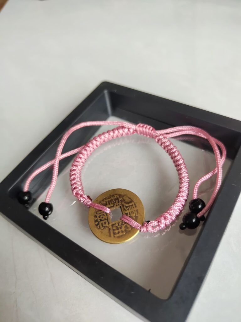 Five Emperor Coins Peach Pink Cord Bracelet handmade with traditional Vajra Knot, adjustable Chinese Feng Shui jewelry for protection.