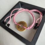 Five Emperor Coins Peach Pink Cord Bracelet handmade with traditional Vajra Knot, adjustable Chinese Feng Shui jewelry for protection.